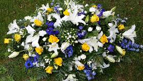 White Lilies with yellow, blue and white flower Coffin Spray